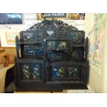 An Oriental carved and decorative side cabinet