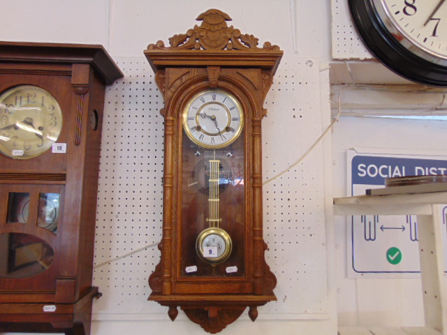 An Oak cased wall clock