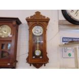 An Oak cased wall clock