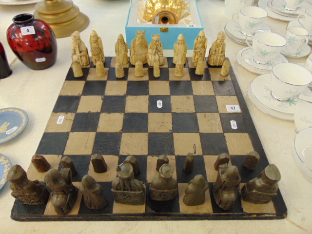 A decorative chess set and board, some pieces slight a.