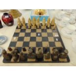 A decorative chess set and board, some pieces slight a.