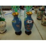 A pair of blue ground Cloissonie vases