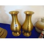 A pair of brass vases,
