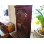 A small glazed corner cabinet