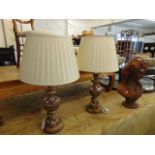 A pair of decorative wood lamps and silk shades