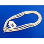 A fresh water Pearl three strand necklace with 14ct Gold clasp and spacers