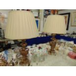 A pair of decorative wood lamps and silk shades