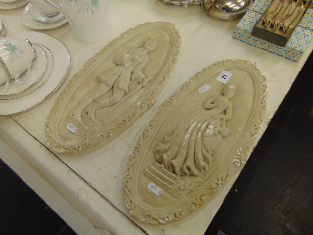 A pair of plaster plaques