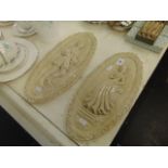 A pair of plaster plaques