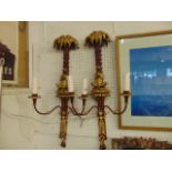 Two electrical wall sconces lamps, with palm tree and seated figure blowing trumpet,