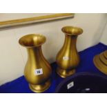 A pair of brass vases,