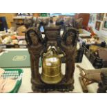 An antique heavily carved table bell
