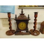 A mantle clock and barley twist candlesticks