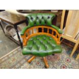 A Green leathered swivel desk chair