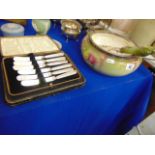 A decorative salad bowl plus servers and two boxed sets of flatware