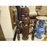 An African figure and two candlesticks