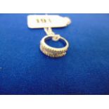 An 18ct White Gold Diamond half eternity ring, set with brilliant cut Diamond baguettes,