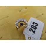 An 18ct Gold Diamond and Sapphire crescent ring