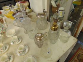 A qty of glassware some Silver tops