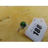 An 18ct White Gold Demantoid garnet, set in Diamond halo mount,