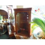 A small glazed corner cabinet