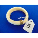 A bangle with 18ct Gold fittings,