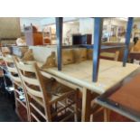 A pine table and four chairs with rush seats,