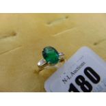 An 18ct Gold Emerald ring surrounded by Diamond baguettes, approx.