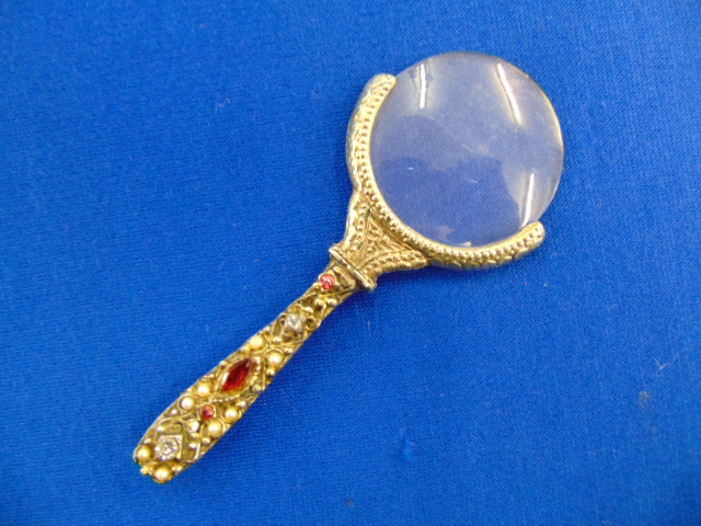 An antique Silver and gem set magnifying glass