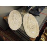 A pair of plaster plaques