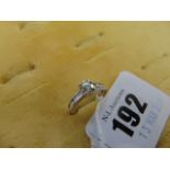 An 18ct White Gold Diamond ring, brilliant cut Diamond centre with baguette cut Diamond shoulders,