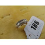 An 18ct White Gold Diamond half eternity ring, set with brilliant cut Diamond baguettes,