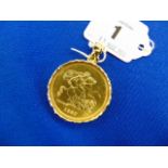 An 1887 Victorian five pound coin, in fine condition set in an 18ct Gold mount,
