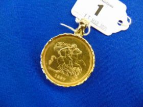 An 1887 Victorian five pound coin, in fine condition set in an 18ct Gold mount,