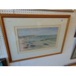 A framed and glazed watercolour of a seashore,