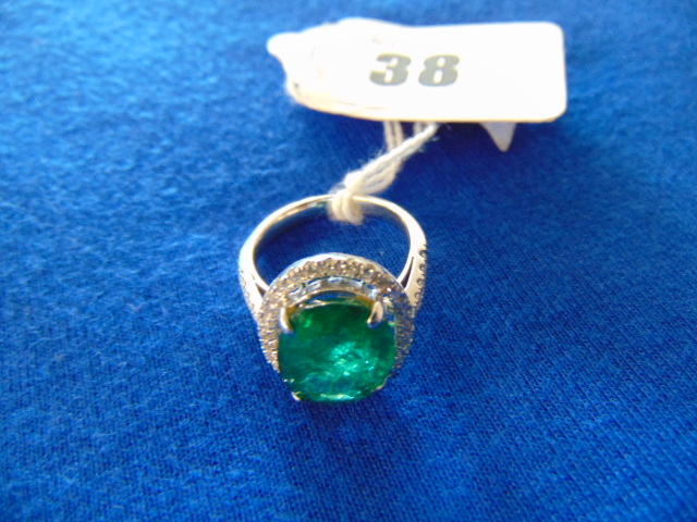 An 18ct White Gold Diamond and Emerald ring,