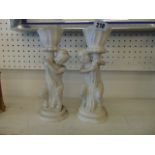 A pair of marble Cherub candlesticks