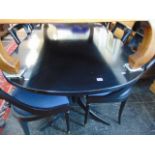 A Harrods black extending dining table and six chairs (length not including leaf 185cm,