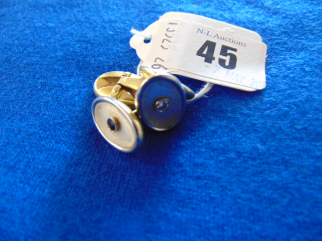 A pair of 18ct Gold cuff links, set with Sapphire, Diamond centre set on Mother of Pearl,