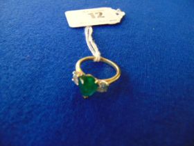 An 18ct Gold Cabochon Emerald set with two Diamonds (.