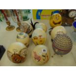 Nine hand painted Ostrich eggs with stands
