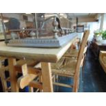 A pine table and four chairs with rush seats,