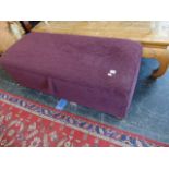 An upholstered Purple Ottoman