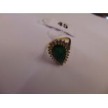 An 18ct Gold, Pear Emerald ring, surrounded by 23 Diamonds, Emerald weight 3 plus carats .