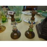 A pair of porcelain figural and metal candle holders