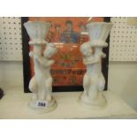 A pair of marble Cherub candlesticks