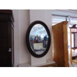 An oval Mahogany framed mirror