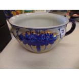A decorative porcelain bowl with handle