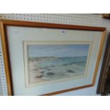 A framed and glazed watercolour of a seashore,