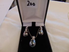 A pair of 18ct White Gold earrings and pendant,